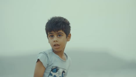 Closeup-shot-of-a-young-Pakistani-boy-in-beach-of-Balochistan,-Pakistan