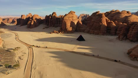 Aerial-view-towards-the-“A-Concise-Passage”-pyramid-by-Rashid-Alshashai-at-Desert-X-in-Al-Ula,-Saudi-arabia