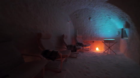 Dim-Lit-Interior-Of-Salt-Cave-With-Chairs-And-Salt-Lamp