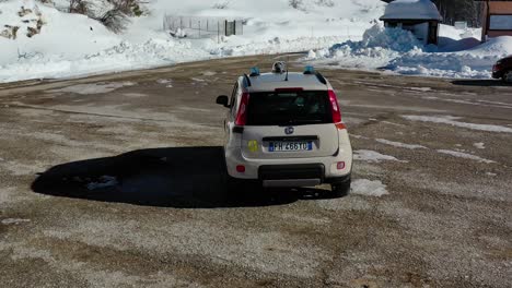 Aerial-view-following-the-park-ranger,-driving-in-the-mountains-of-Abruzzo,-Italy