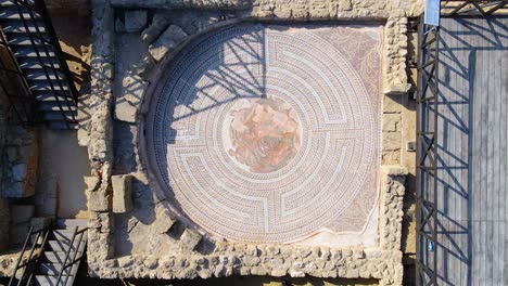 Aerial-view-rising-above-Mosaic-art,-at-Kato-Paphos-Archelogical-park,-in-Cyprus---top-down,-drone-shot