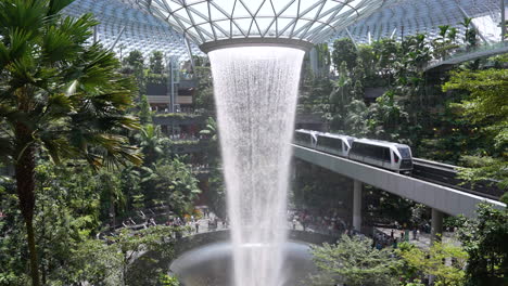 Anti-Gravity-Time-Warp-Reverse-Moving-Artificial-Indoor-Waterfall-surrounded-by-Lush-Green-Forest-Inside-Modern-Luxury-Shopping-Mall
