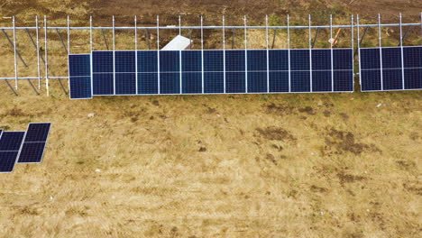 Solar-panel-farm-construction-site-in-progress,-aerial-top-down-view