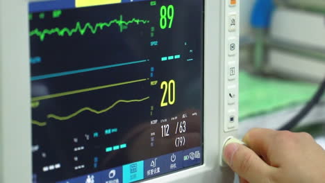 Modern-Medical-Ecg-Equipment-Monitors-Pulse-Of-Patients-Heart-At-Hospital,-Monitor-With-Vital-Signs-Of-Patient-Change-Information-By-Nurse