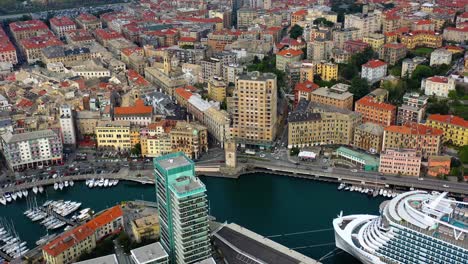 Aerial-view-of-a-cruise-liner-and-the-cityscape-of-Savona,-Italy---panorama,-drone-shot