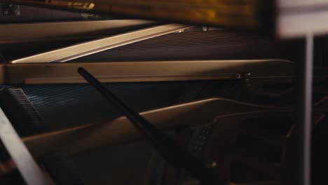 a-tight-shot-of-the-interior-of-a-grand-piano-showing-the-inter-workings-of-the-instrument,-including-the-strings