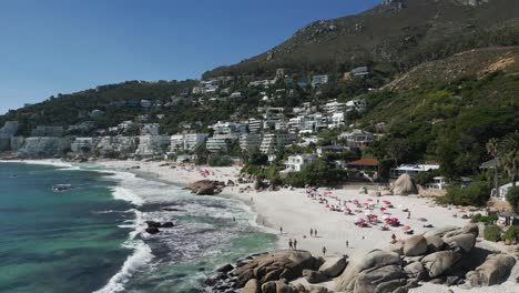 Drone-shot-of-waves-crashing-onto-the-beach-at-Cape-Town,-South-Africa