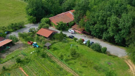 Aerial-view-around-a-winery-in-rural-Piedmont,-sunny-Italy---circling,-drone-shot