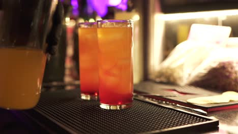 Two-colorful-tequila-sunrise-cocktails-prepared-on-the-bar-counter