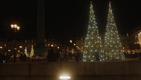 People-stroll-and-are-enchanted-by-the-illuminations-of-the-dazzling-Christmas-tree-lights-decorations-in-Paris
