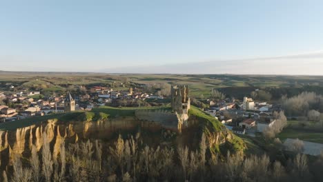 Historical-rich-architecture-in-cliff-green-fields-Cea-castle-and-town-in-Leon-Spain-landscape-drone-aerial-zooming-panoramic-out