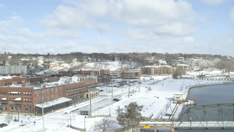 Aerial-rising-establishing-downtown-Stillwater-in-Minnesota-in-winter-with-snow