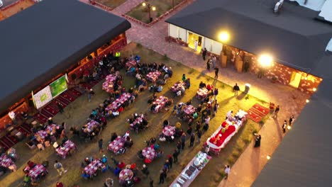 Aerial-view-over-people-eating-an-arabian-dinner-at-a-outdoor-restaurant,-in-Saudi-Arabia