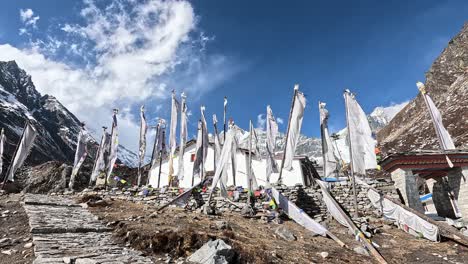 White-prayer-flags-in-the-wind-in-front-of-icy-valley-of-Kyanjin-Gompa