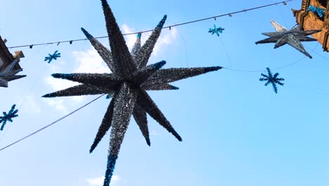 Kippaufnahme-Eines-Riesigen-Mexikanischen-Weihnachts-Piñata-Sterns-Mit-Alten-Gebäuden-Und-Blauem-Himmel-Im-Hintergrund