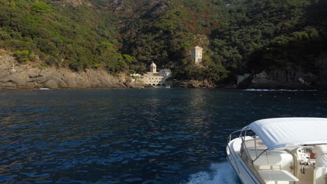 Vista-Aérea-De-Una-Pareja-En-Un-Romántico-Viaje-En-Barco,-En-La-Abadía-De-San-Fruttuoso,-En-La-Soleada-Italia