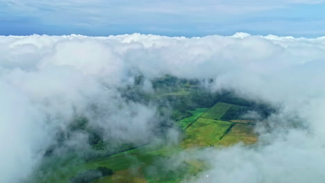 Aerial-View-Of-White-Clouds-Over-The-Green-Fields-In-Daytime