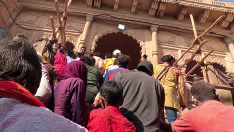 pov-shot-People-are-moving-towards-the-temple-with-great-joy-and-different-colors-and-traditional-dance