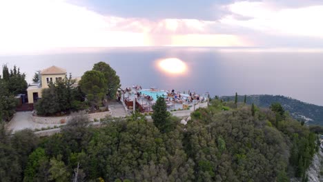 A-panoramic-view-of-the-sea-and-a-luxury-restaurant-standing-on-top-of-a-hill,-Lefkada,-Greece