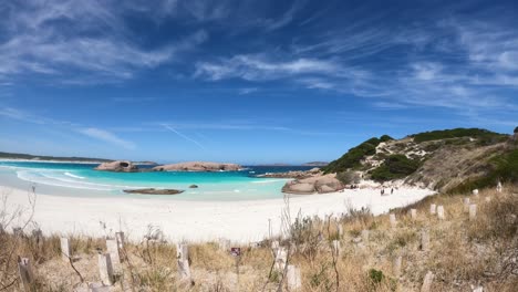Time-lapse-shot-of-tourist-at-sandy-beach-in-Esperance-with-turquoise-ocean-bay-in-Western-Australia