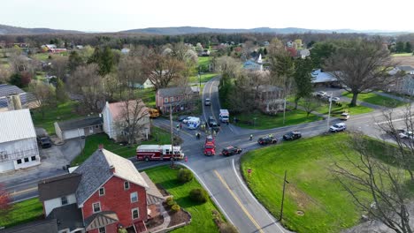 Aerial-approaching-shot-of-accident-scene-on-road-in-american-suburb-district