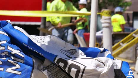 Static-shot-of-a-cement-bags-with-laborers-pouring-concrete