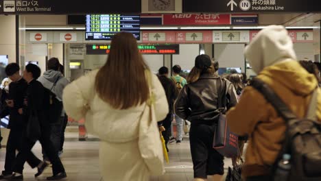 Shibuya-Train-Station,-Commuters-walking-through-ticket-gates,-Tokyo,-Japan