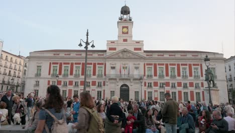 Wide-view-of-large-crowds-of-people-gathering-and-spending-their-evening-at-the-Puerta-del-Sol,-an-iconic-landmark-of-Madrid