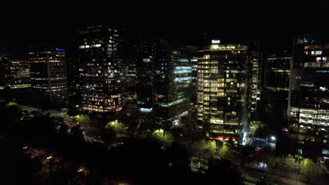 Nighttime-cityscape-of-Santiago-Chilean-Capital-at-Night-in-Nueva-las-condes-modern-neighborhood,-high-buildings-lighting,-establishing-shot-city-panoramic