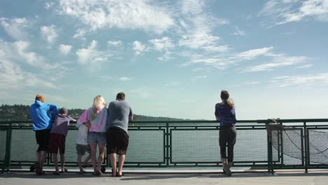 People-enjoying-the-view-from-a-ferry-as-they-commute-between-cities