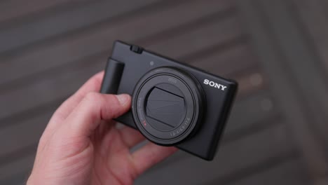 Person's-Hand-Holding-And-Checking-The-Exterior-Body-Of-Sony-Mirrorless-Camera