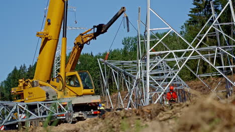 Kranmaschine-Und-Ingenieure-Auf-Der-Baustelle,-Befestigung-Des-Strommastturms-Für-Neues-Stromnetz