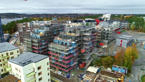 Aerial-footage-of-two-buildings-completely-surrounded-by-metal-scaffolding
