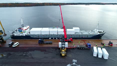 A-ship-is-loaded-with-white-containers-at-the-quay-of-the-port-of-Riga