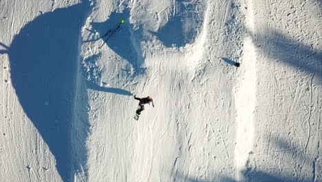 Drone-filming-a-Snowboarder-jumping-filmed-by-a-drone,-Ax-Les-Thermes-Bonascre