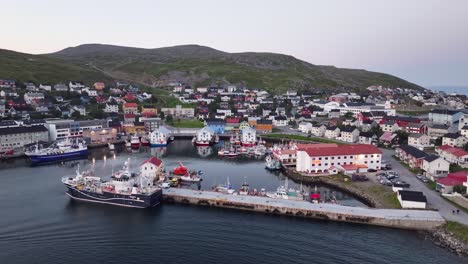 Aerial-View-of-Honningsvag-Norway-Port-Town,-Boast-and-Waterfront-Buildings-After-Sunset,-Drone-Shot-60fps