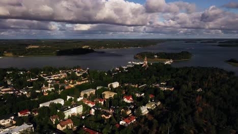 Aerial-view-circling-the-church-and-old-town,-golden-hour-in-Naantali,-Finland