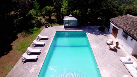 Drone-Elevation-Reveals-Luxury-Villa-with-Pool,-Veranda-and-Tropical-Garden