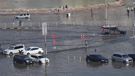 On-April-19,-2024,-traffic-navigated-through-a-flooded-road-in-the-northern-Emirates-of-the-UAE-after-record-breaking-rains-hit-the-country