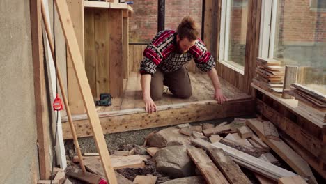 Worker-Installing-Wood-Interior-Of-Greenhouse.-static-shot