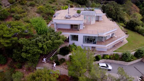 Luxury-Real-Estate-Tour:-Aerial-View-of-Agent-and-Clients-Entering-Magnificent-Two-Storey-Villa-on-Monaco's-Heights