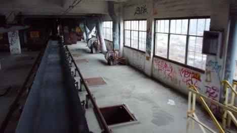 Inside-abandoned-factory-with-conveyor-belt-building-full-of-graffiti-Montreal-Canada