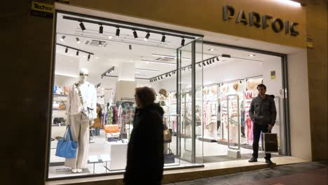 A-customer-waits-at-the-entrance-of-the-Portuguese-women's-accessories-brand-Parfois-store-in-Spain