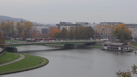 Residential-buildings-and-bridge-on-the-Vistula-River-in-the-city-of-Krakow,-Poland