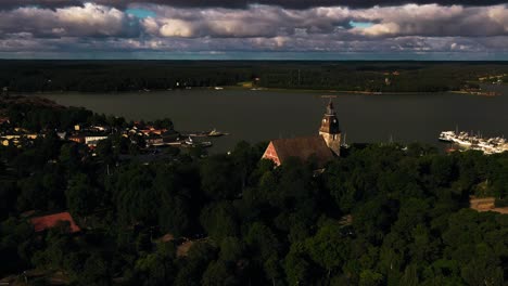 Aerial-tracking-shot-of-the-church-and-old-town-Naantali-harbor,-summer-in-Finland