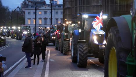 A-convoy-of-tractors-arrive-in-Westminster-at-dusk-on-a-protest-defending-British-farmers
