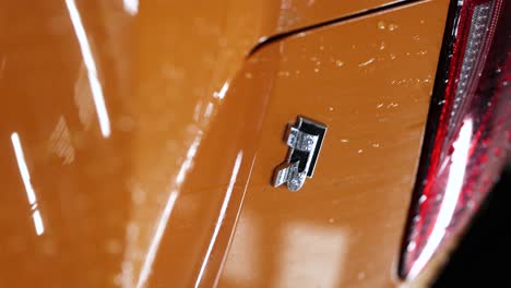 Close-up-of-R-badge-on-trunk-of-magma-orange-Golf-spektrum-edition-car