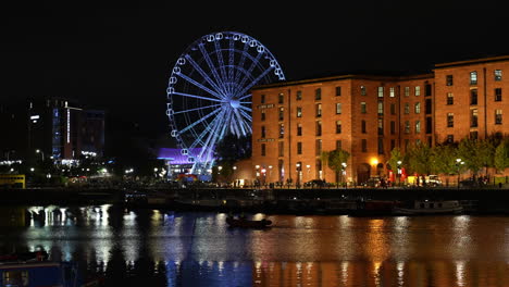 Liverpool,-England-UK-at-Night,-Illuminated-Ferris-Wheel-and-Waterfront-Buildings-Reflections-on-Water