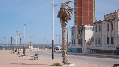 Old-houses-next-to-a-newly-built-tall-building-in-Mostaganem,-Algeria