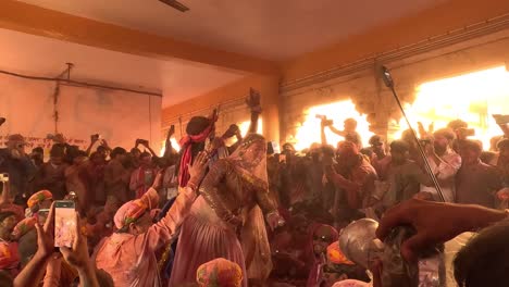 pov-shot-Many-people-are-coming-to-watch-the-Ghumar-dance-inside-the-temple